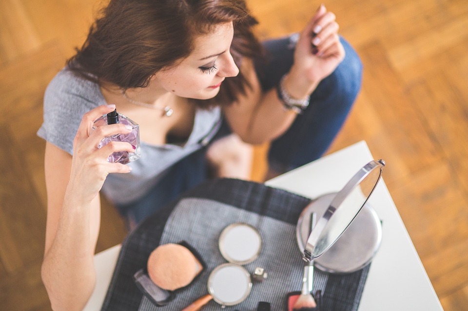 girl spraying perfume 